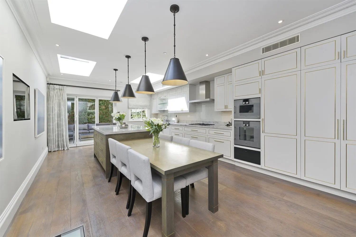 Kitchen with roof lights and a dining table
